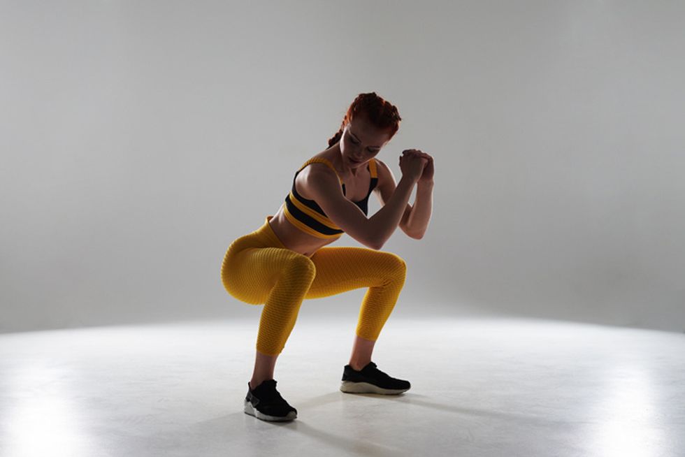 woman in sportswear doing a squat