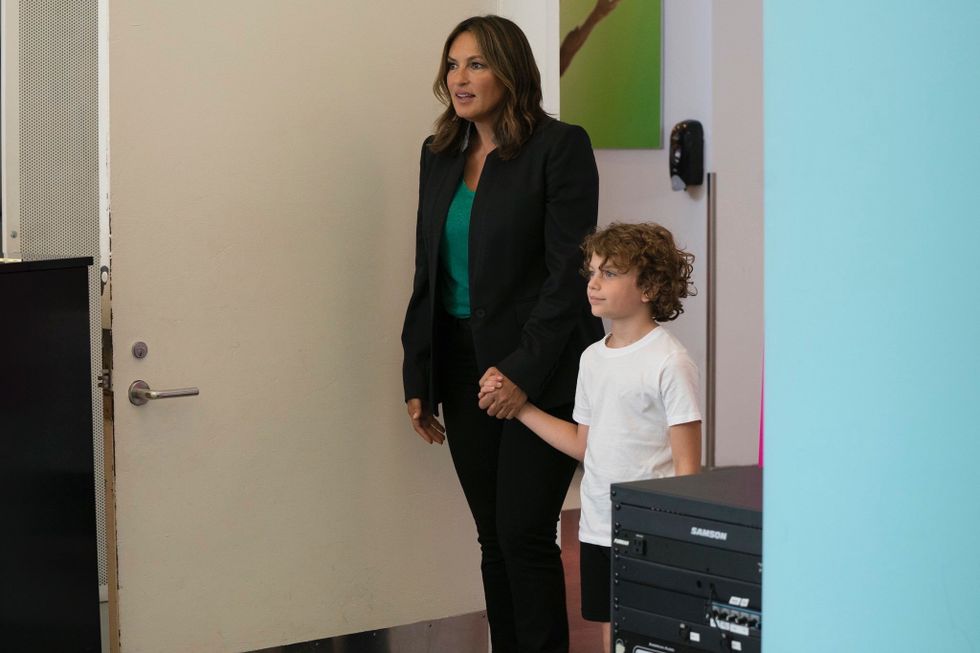Mariska Hargitay walks into a dance studio holding the hand of her character's son, who expectantly smiles.