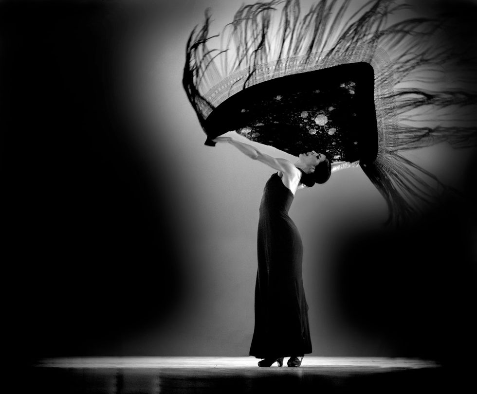 Black and white photo of Irene Rodriguez dancing with a scarf