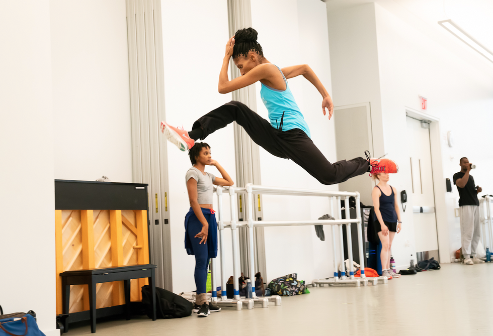 Ailey's Jacqueline Green leaps with her hand to her head