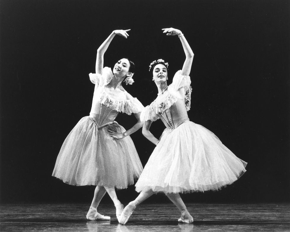 Yan Chen onstage with Alessandra Ferri in romantic tutus, leaning toward each other on a bent pliu00e9 leg