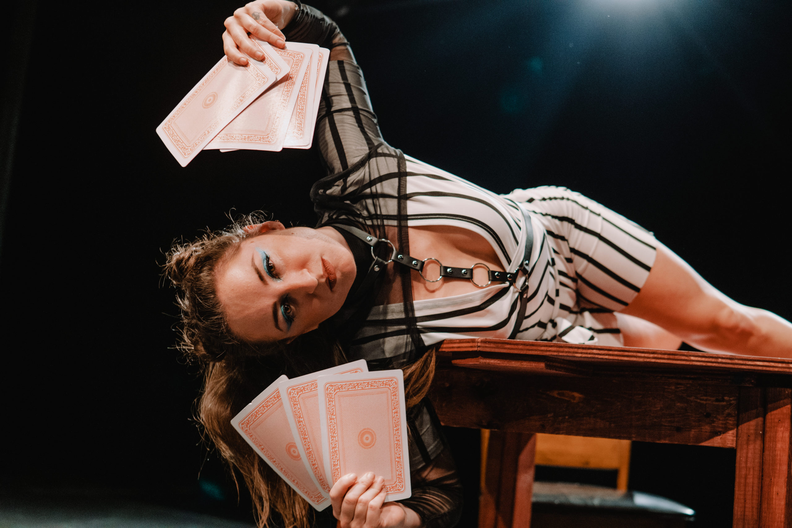 dancer wearing striped costume laying on a table