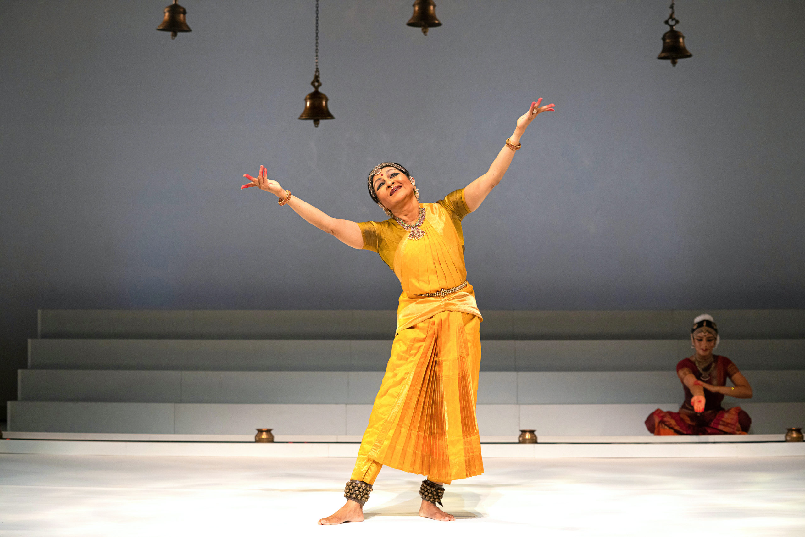 woman wearing yellow dress dancing on stage