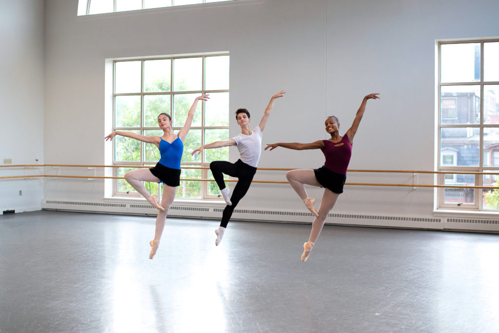 3 dancers jumping in retire in the studio 