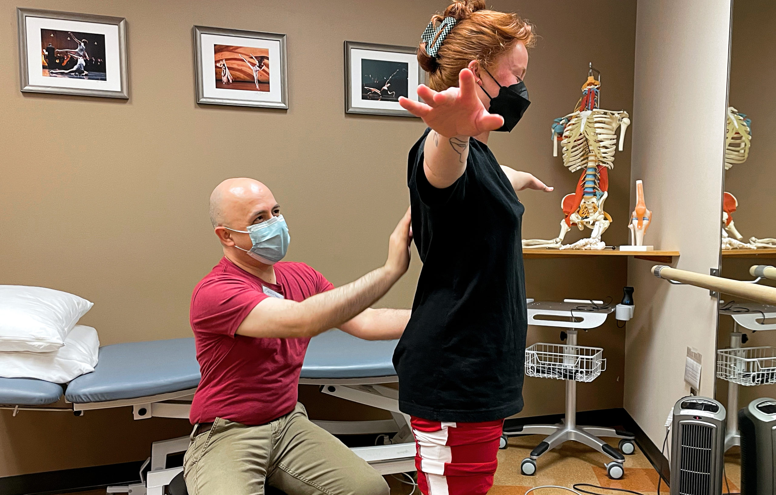 doctor correcting alignment on dancer