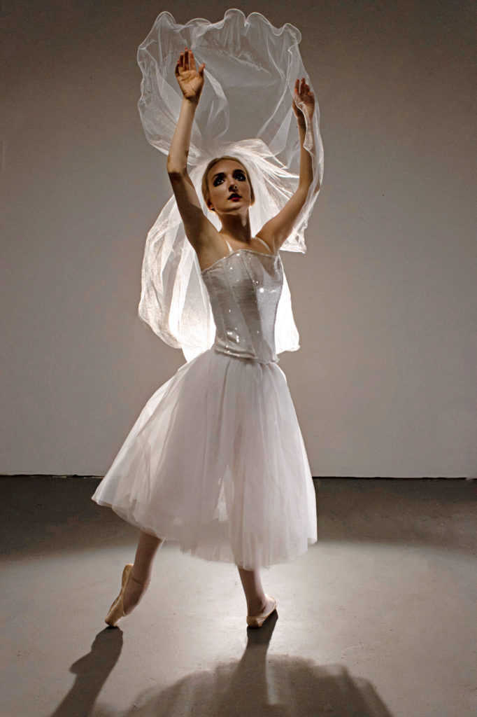 dancer wearing white dress with white veil 
