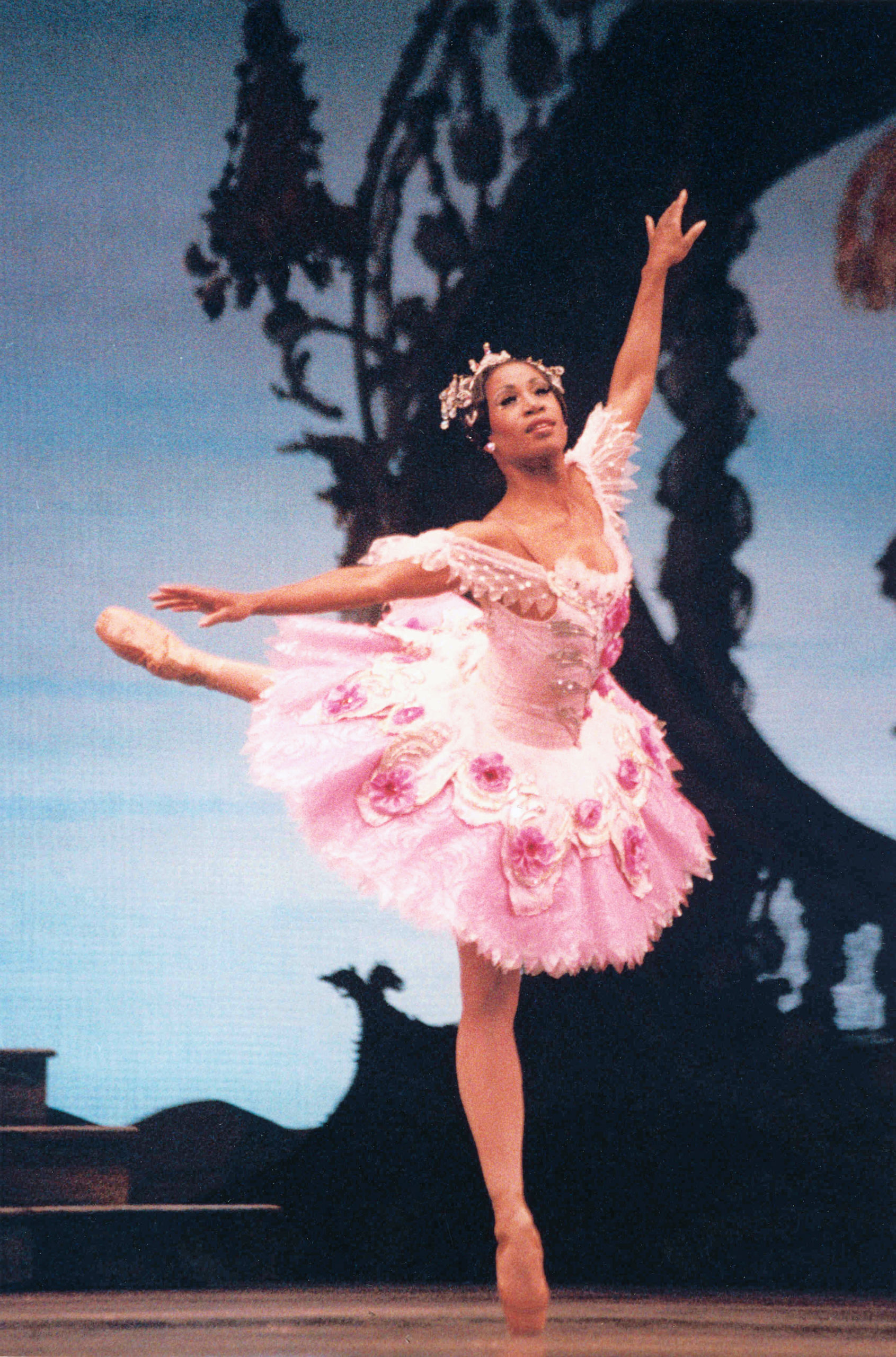 dancer wearing pink tutu performing attitude derriere on stage