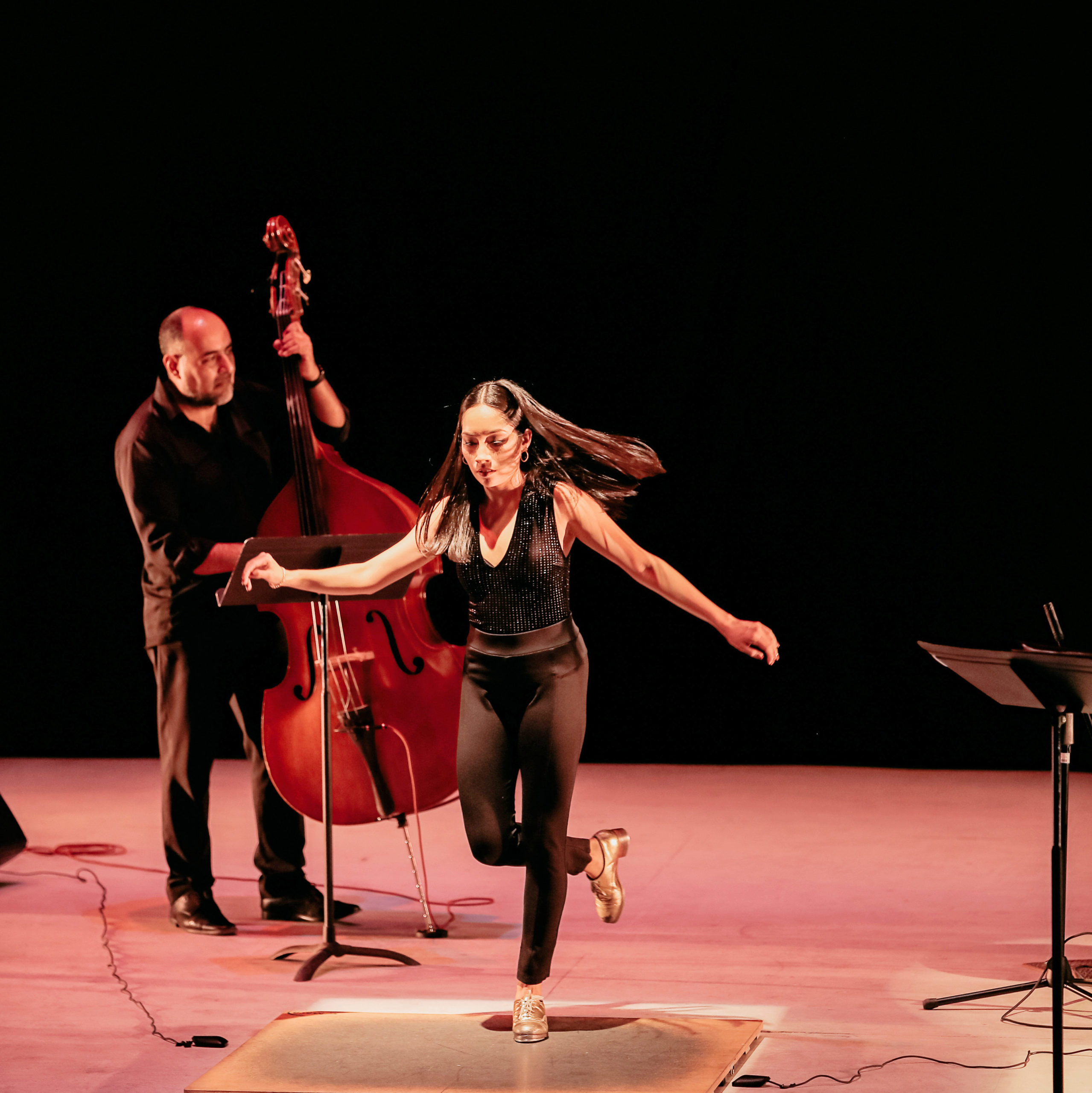 female dancer tapping on stage with musicians 