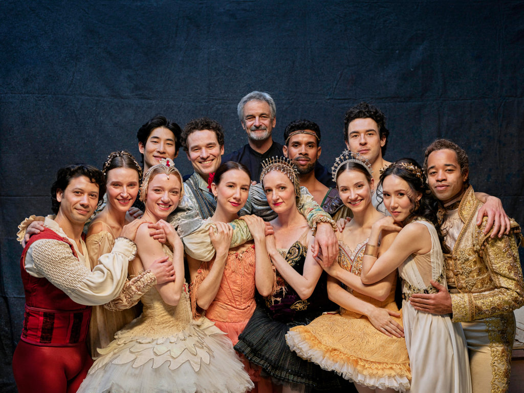 a large group of dancers hugging 