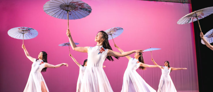 female dancers performing with umbrellas