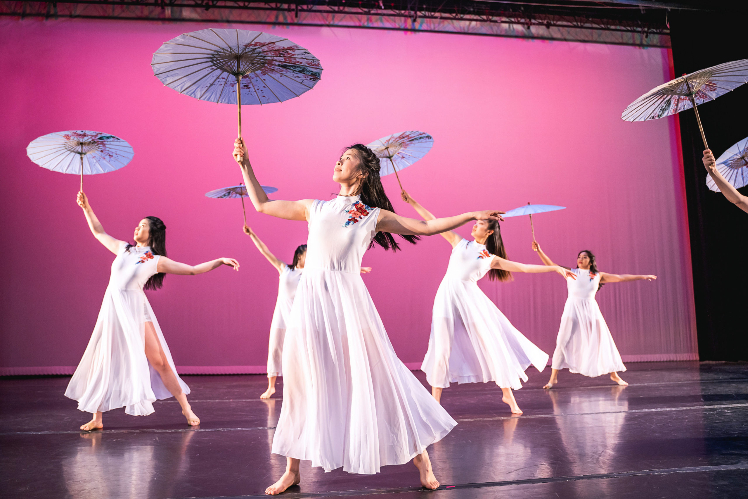 female dancers performing with umbrellas