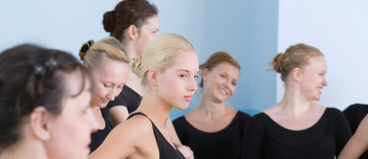 female dancers wearing black leotards, blonde girl looks jealous