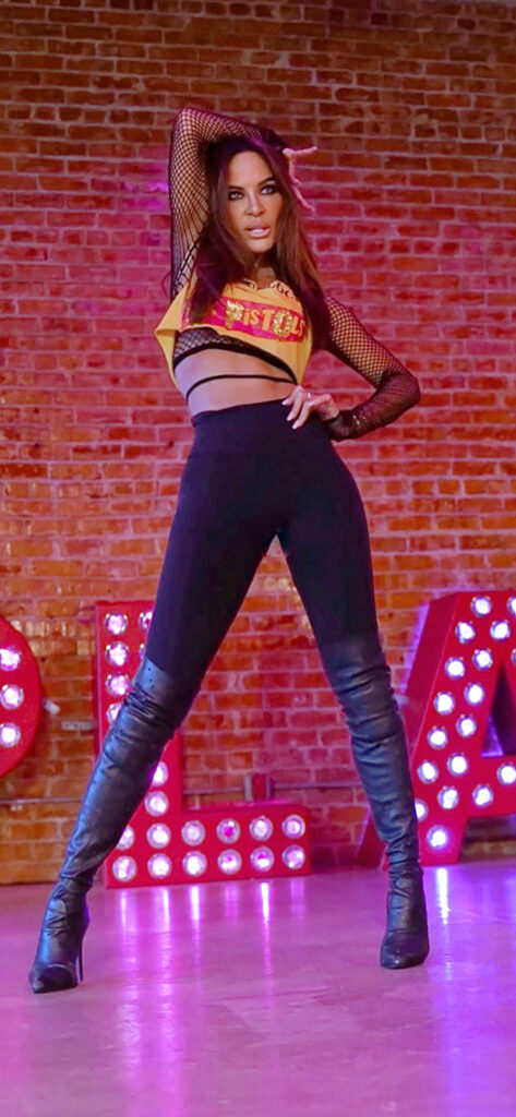 woman wearing high heel boots and crop top