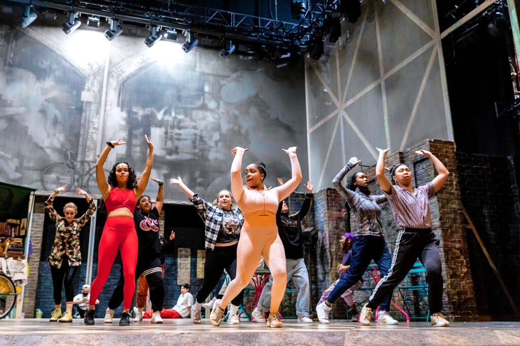 a group of dancers rehearsing on stage 