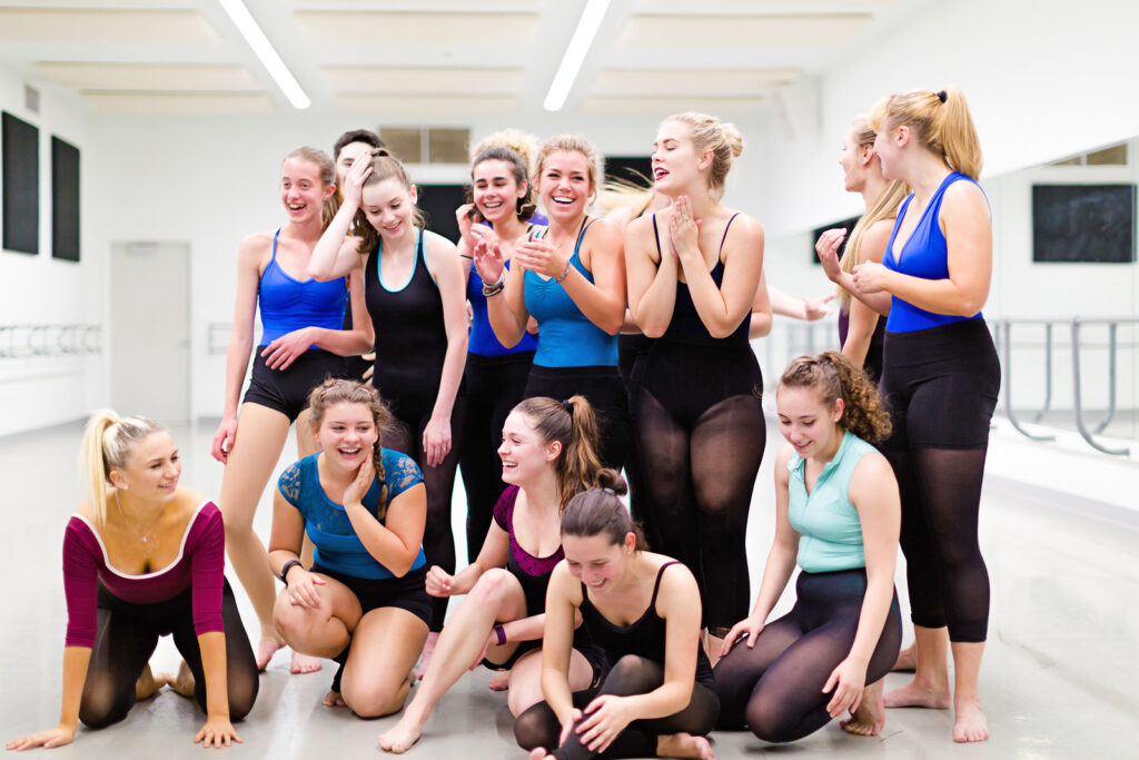 female dancers wearing leotards and tights standing together in the studio