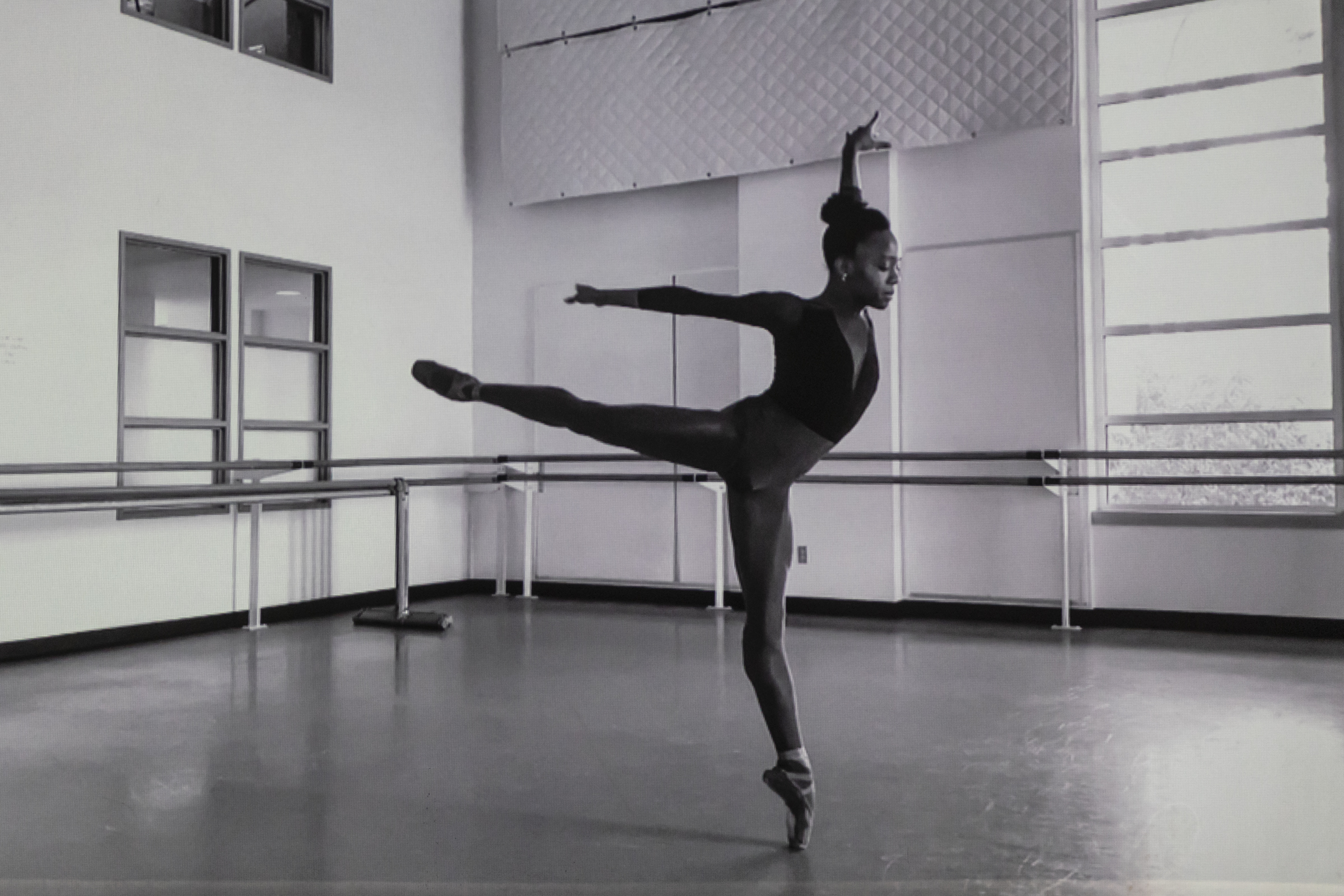 Ashton Edwards does an arabesque in profile in a black and white still from "Bright Young Things"