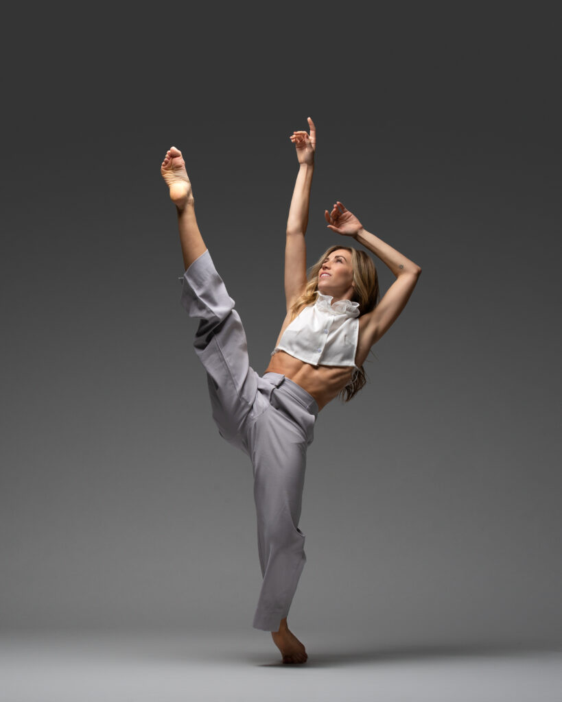 a female dancer extending on leg devant