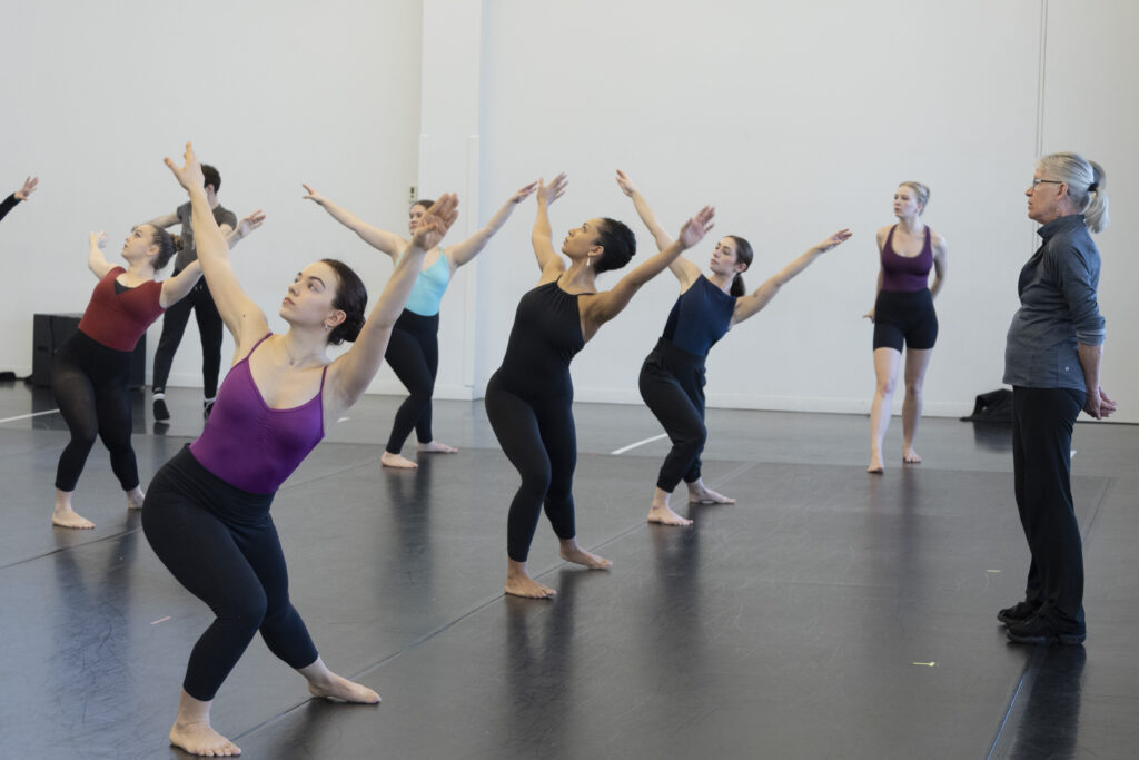 a group of dancers lunging and spiraling to the right