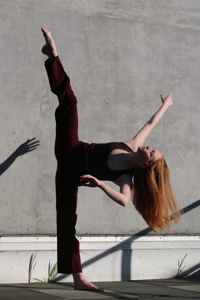 a female dancer performing a tilt outside 