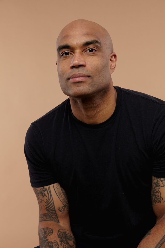 a man wearing a black shirt looking at the camera