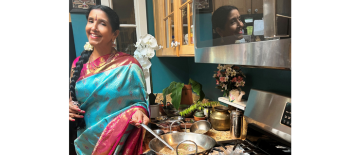 a woman wearing traditional Indian clothing stirring a pot on the stove