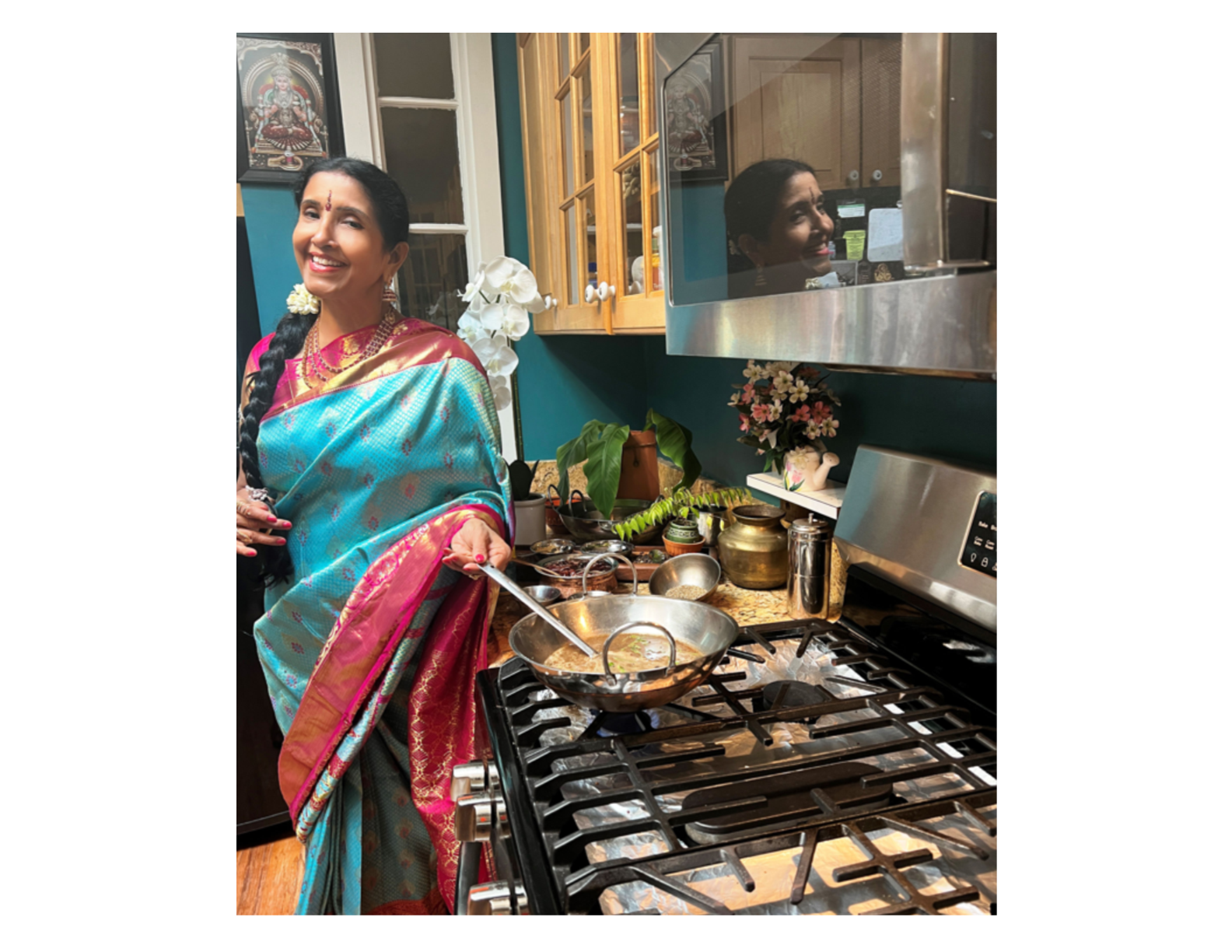 a woman wearing traditional Indian clothing stirring a pot on the stove