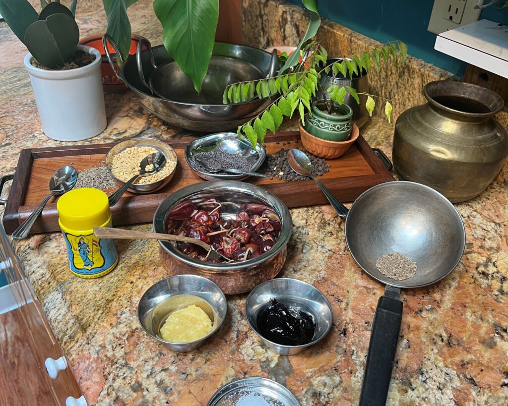 a counter top with spices and seeds  in small bowls 