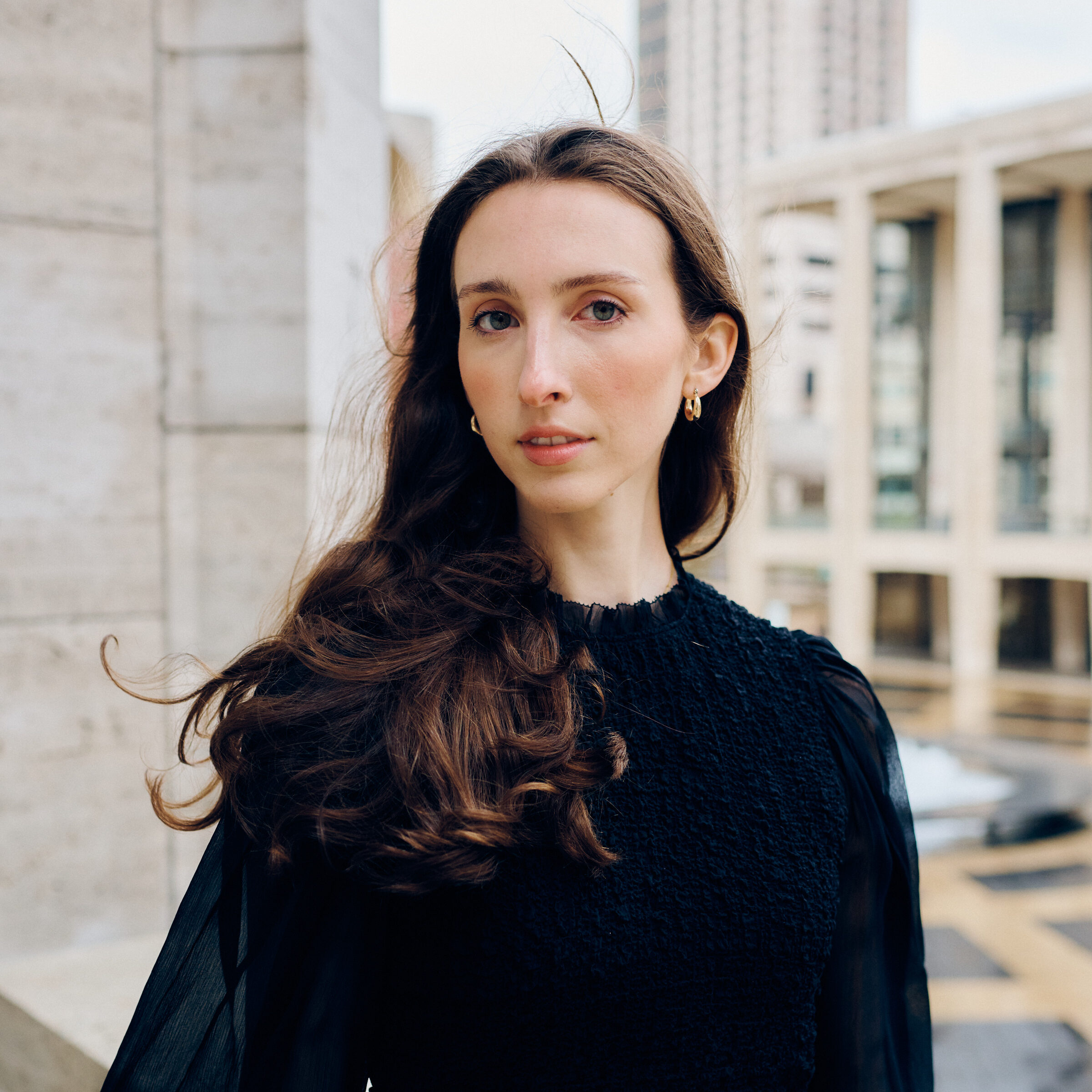 a female with long brown hair looking at the camera 