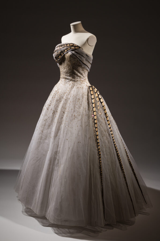a mannequin wearing a long ballgown made out of grey and white tulle