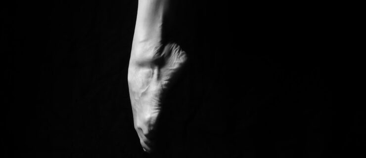 a dancer's foot pointing down as they jump