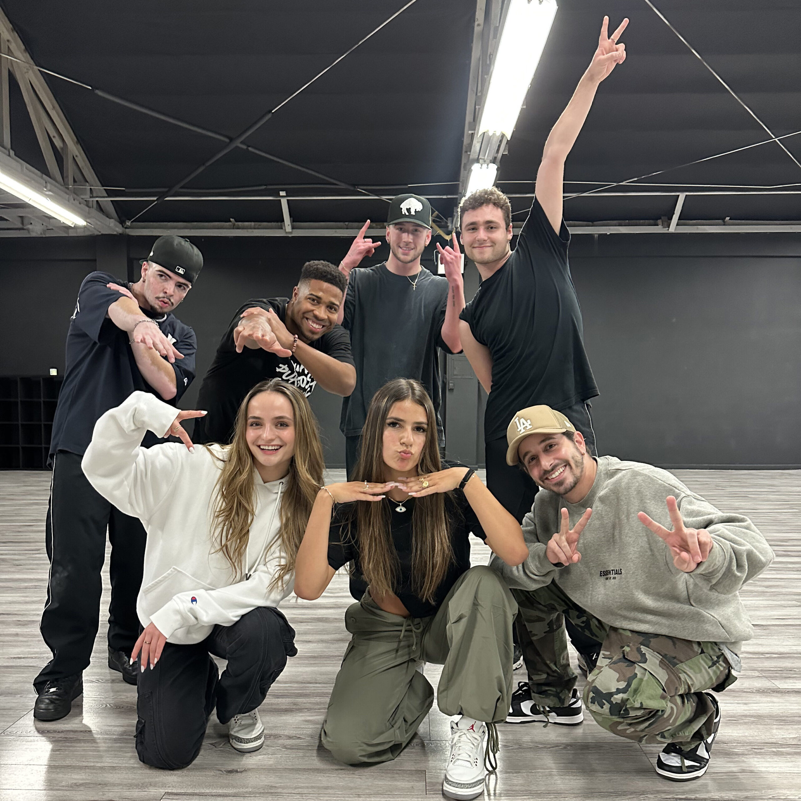 a group of dancers in a studio posing for a candid photo